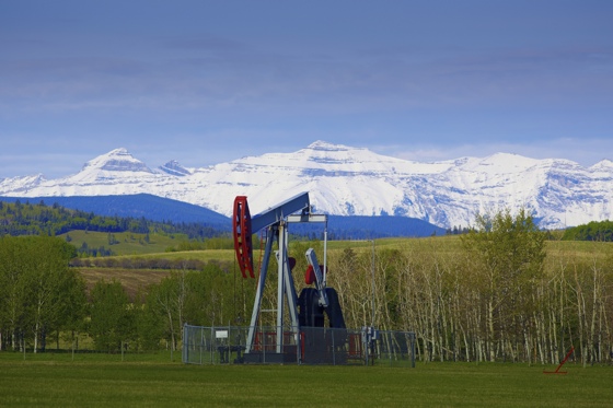 Oil well in front of mountains